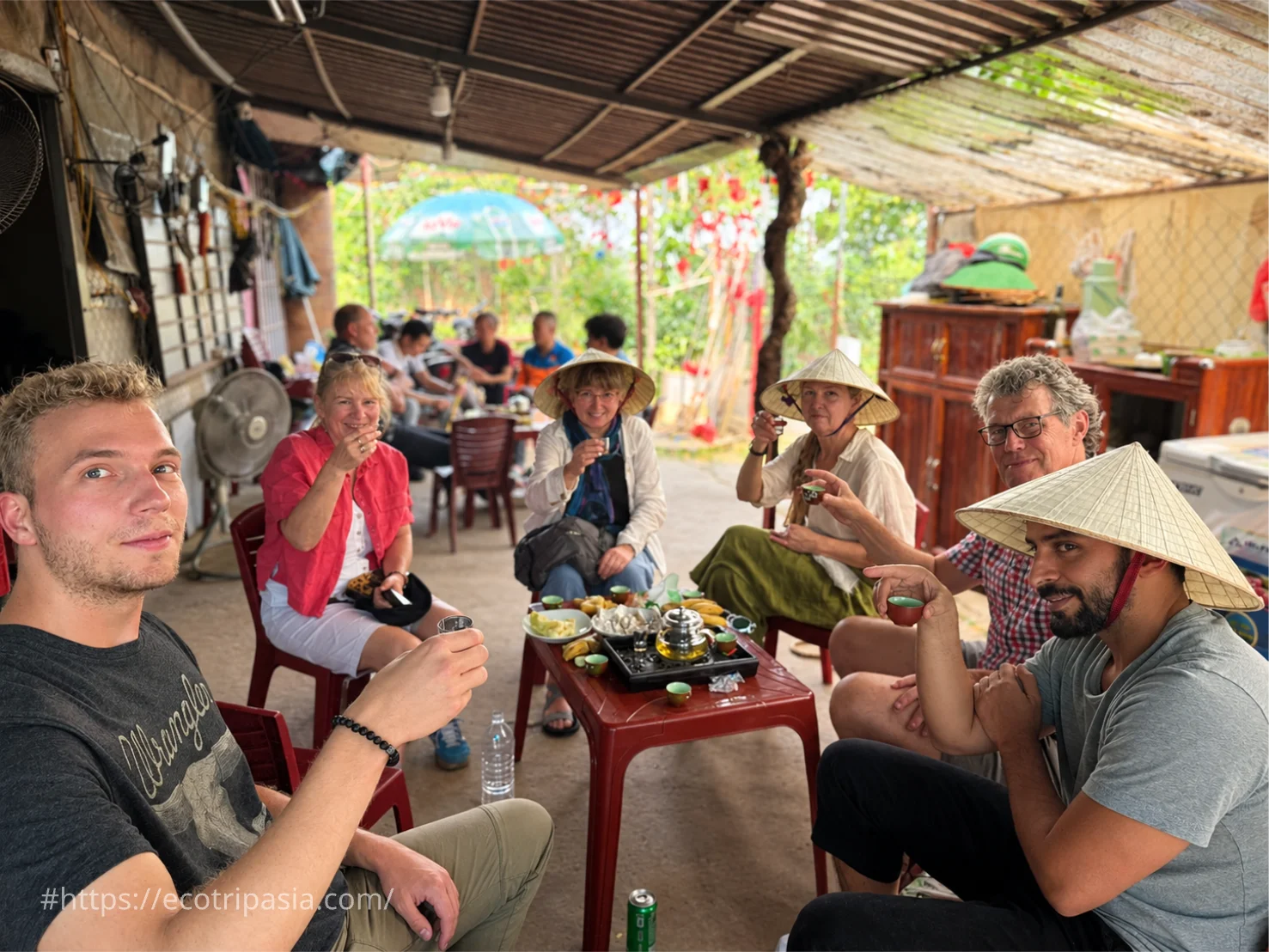 Guests Sharing Seasonal Fruits And Tea With Locals — hanoi street food tour with female riders by Eco Trip Asia