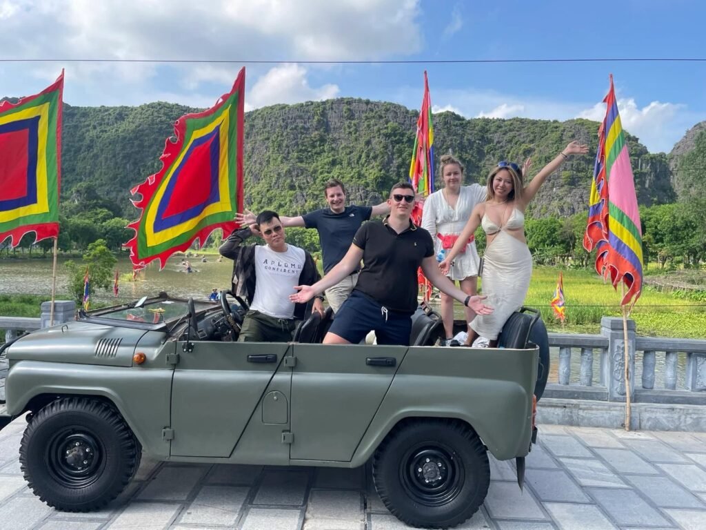 Guests with their jeep in front of festival flags at a Ninh Binh temple